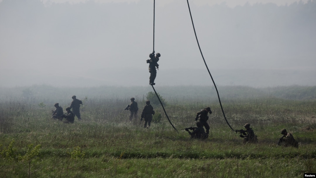 Polish soldiers from 25th Air Cavalry Brigade land during the Defender Europe 2022 military exercise of NATO troops at the military range in Bemowo Piskie, near Orzysz, Poland, on May 24, 2022.