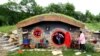 BOSNIA AND HERZEGOVINA -- Marija Milicevic (R) and her sister Vedrana at the Hobbit house in the village of Rakova Noga, near Kresevo, Bosnia and Herzegovina, 13 June 2023.