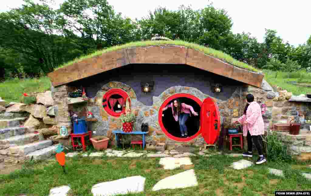 Marija Milicevic (right) and her sister, Vedrana, visit the Hobbit house in the village of Rakova Noga, near Kresevo, Bosnia and Herzegovina.