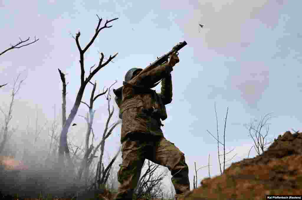 A Ukrainian soldier fires a rocket-propelled grenade at Russian forces.