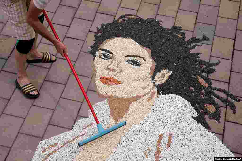 Kosovar artist Alkent Pozhegu works on a mosaic portrait of Michael Jackson on the 15th anniversary of his death, in Gjakova, Kosovo, on June 25.
