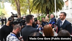 New Prime Minister Milojko Spajic speaks with journalists after the vote on October 31.