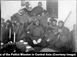 One of the expedition's accompanying Cossacks, named Ilyazov (center), during an evening of music in China