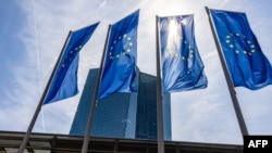 European flags fly in front of the European Central Bank in Frankfurt am Main, Germany. 