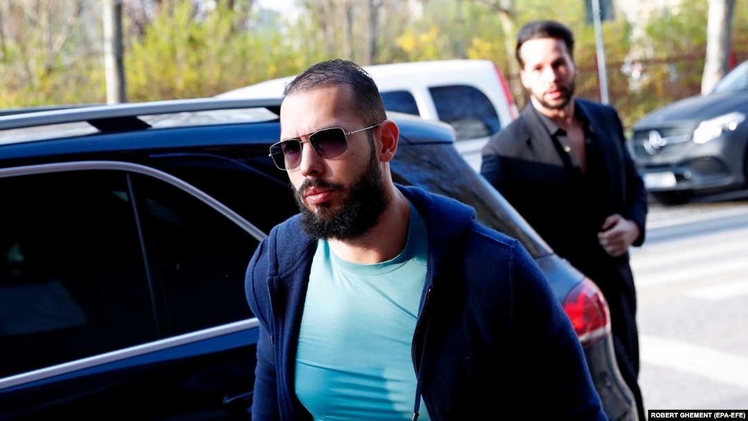 Andrew Tate (center), followed by his brother Tristan, arrives for questioning at the Directorate for Investigating Organized Crime and Terrorism headquarters in Bucharest in April.