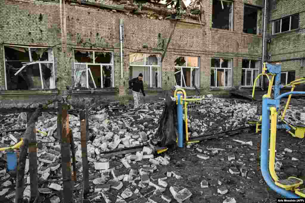 A man walks outside a destroyed school after a Russian missile strike in Kramatorsk amid Russia&#39;s invasion of Ukraine.