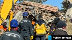 Turkey - Armenian and Turkish rescuers dig through the rubble of a collapsed building in Adiyaman, February 11, 2023.