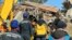 Turkey - Armenian and Turkish rescuers dig through the rubble of a collapsed building in Adiyaman, February 11, 2023.