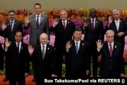 World leaders, including China’s Xi Jinping (second right) and Russia’s Vladimir Putin (second left), wave for a group photo at the third Belt and Road Initiative Forum in Beijing on October 18.