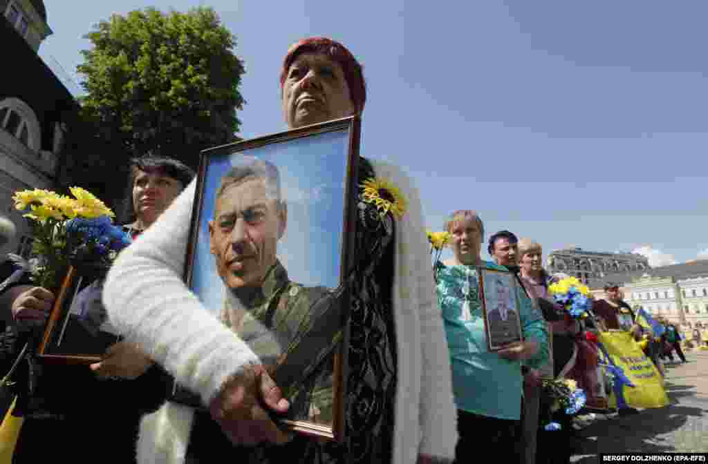 Relatives and friends gather at the Memory Wall to fallen Ukrainian soldiers to pay tribute near the St. Mykhail Cathedral in Kyiv on May 12.