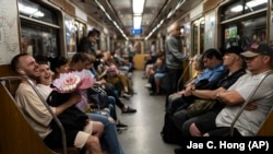 Nevető pár a kijevi metrón 2023. július 8-án. A felszínen normálisnak tűnik az élet a háború sújtotta ország fővárosában, ám a felszín alatt másik történet rejtőzik