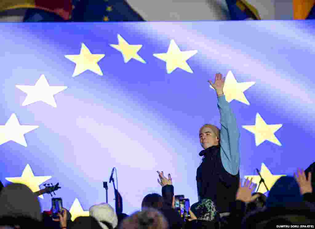 Moldovan singer Satoshi performs in front of the presidential palace in Chisinau during an event held to mark a historic decision that enables the country to start accession negotiations with the European Union.&nbsp;