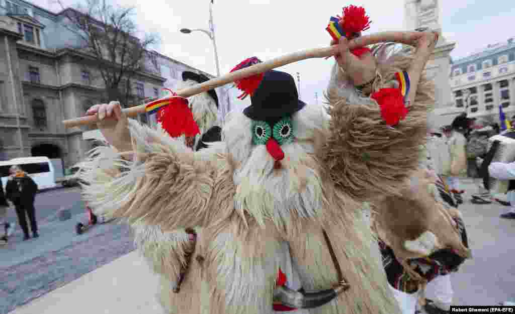 A man dressed in fur and a mask dances in Bucharest. The organizers of the International Festival of Winter Traditions also said that the Bucharest event was aimed at &quot;increasing the visibility of Romanian culture internationally.&quot;