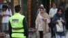 An Iranian police officer stands on a street during the revival of patrols by the so-called morality police in Tehran on July 16.