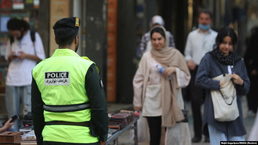 An Iranian police officer stands on a street during the revival of patrols by the so-called morality police in Tehran on July 16.