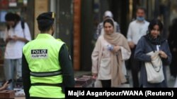 An Iranian police officer stands on a street during the revival of patrols by the so-called morality police in Tehran on July 16.