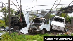 Three trucks damaged by a glide bomb that hit a pole barn.