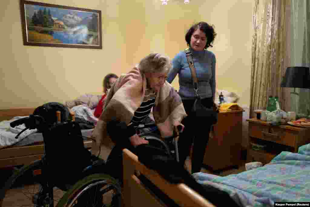 Oksana helps Melnichenko out of her wheelchair in a room she shares with two other refugees. &quot;I don&#39;t bother anyone. The staff here are very helpful. I receive warm meals. What else would an old person need?&quot; she said.&nbsp;&quot;But I want to go back to Ukraine.&quot;&nbsp;&nbsp;