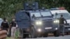 Kosovar police officers evacuate a wounded person near the Banjska Monastery in the village of Banjska on September 24. 