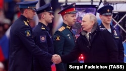 Russian President Vladimir Putin greets military officers at an open-air concert and rally titled "Glory to Defenders of Our Fatherland" on February 22, on the eve of the country's annual day for celebrating its armed forces and comemorating the establishment of the Red Army. 