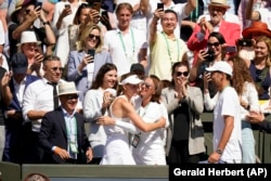 Rybakina hugs members of her team after the final of the ladies' singles at Wimbledon on July 9, 2022.
