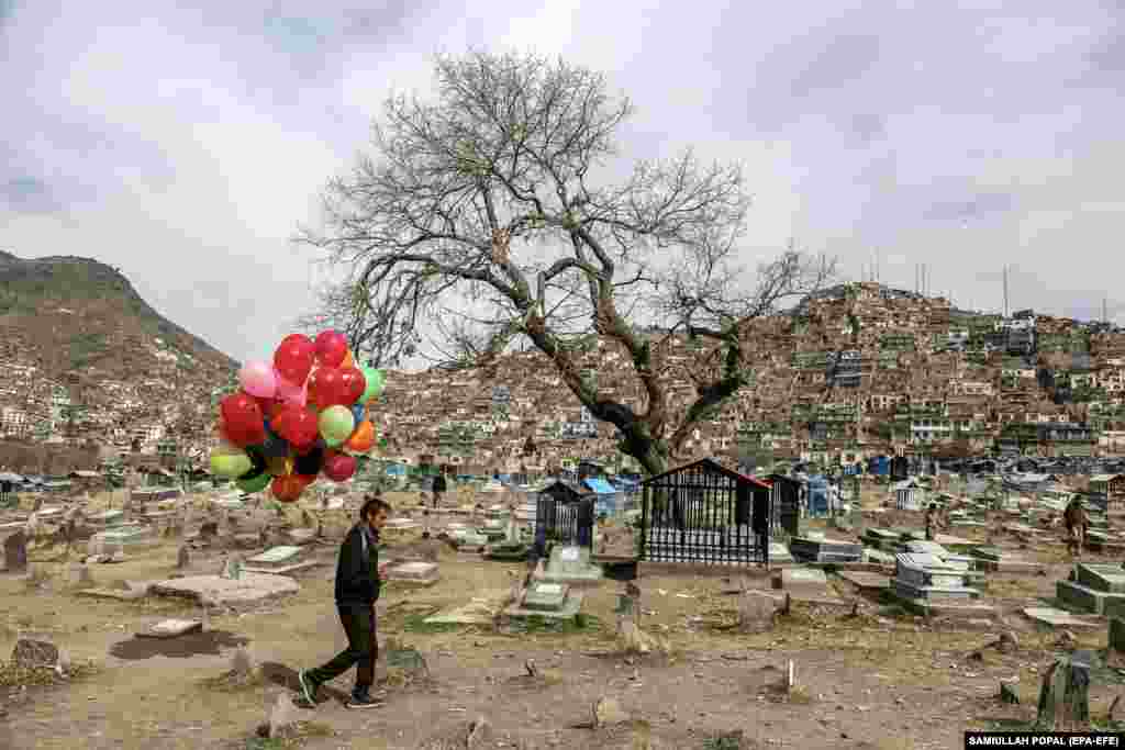 An Afghan street vendor carries balloons for sale during Norouz&nbsp;celebrations in Kabul.