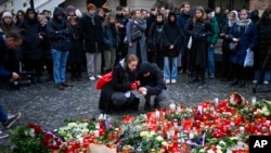 Mourners lay candle lights outside the headquarters of Charles University on December 22 for victims of a mass shooting in Prague the day before. 