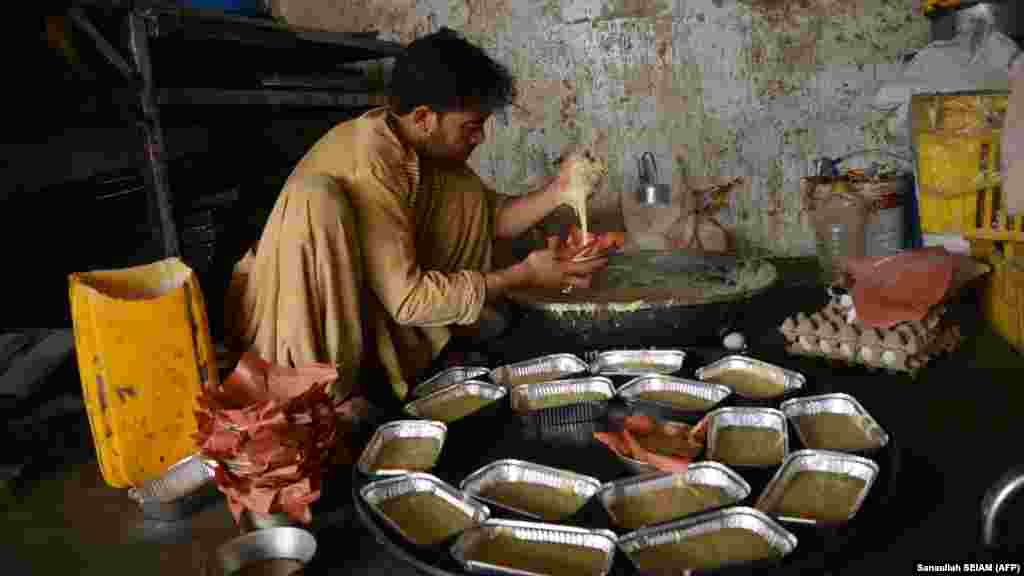 A worker prepares cakes in Kandahar. On average 90 percent of household income in Afghanistan is spent on food.