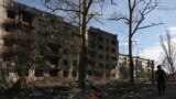 A man passes houses destroyed by artillery fire and air raids in the village of Ocheretyne in the Donetsk region in mid-April.