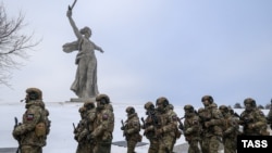 Russian soldiers on their way to Ukraine march past the Motherland Is Calling statue in Volgograd in January 2023.