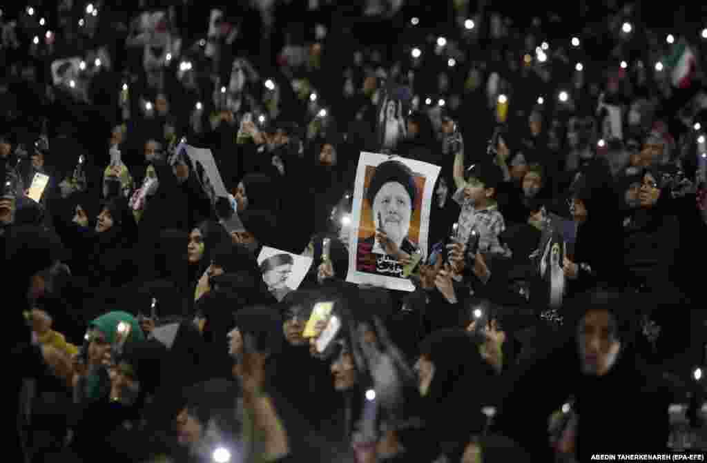 Iranians hold posters of Raisi as during funeral processions at the Mossallah mosque in Tehran.&nbsp;
