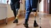 UKRAINE -- Wounded Ukrainian servicemen with prosthetic legs walk with crutches at a rehabilitation center near Lviv, western Ukraine, 22 February 2023