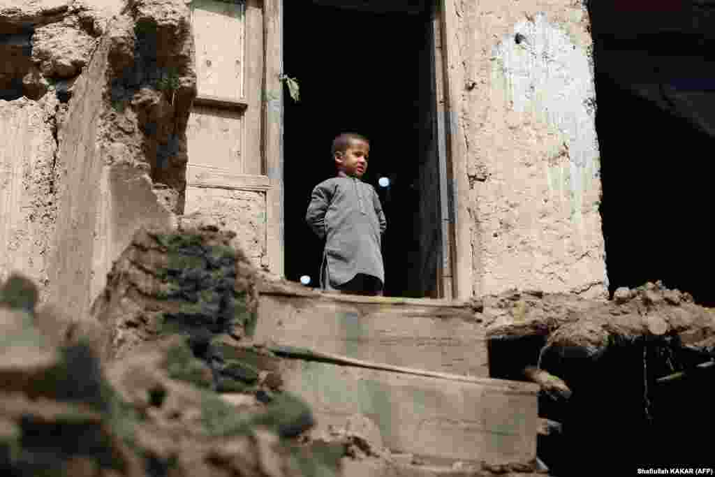 A boy looks out from his damaged home in the Alishing district of Afghanistan&#39;s Laghman Province on March 22 following an overnight earthquake.