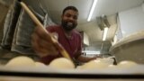 Tharshan Selvarajah, winner of the best baguette of Paris, preparing baguettes, May 2023.