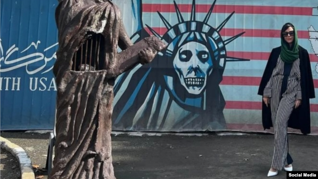 American porn star Whitney Wright poses in front of the former U.S. Embassy in Tehran.
