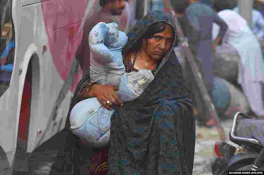 An Afghan woman is seen as as refugees prepare to depart for their homeland in Karachi, Pakistan, on October 30. Pakistan&#39;s government earlier this month ordered all illegal Afghan immigrants to leave the country by the end of October or face expulsion.