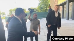 ირაკლი ღარიბაშვილი ხელს ართმევს თეიმურაზ კალანდაძეს.