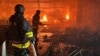 Ukrainian firefighters battle a blaze at a shopping mall hit by a Russian air strike in Kharkiv on May 25.