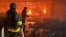 Ukrainian firefighters battle a blaze at a shopping mall hit by a Russian air strike in Kharkiv on May 25.