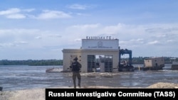 A Russian Investigative Committee officer at the breached Kakhovka Dam, June 2023