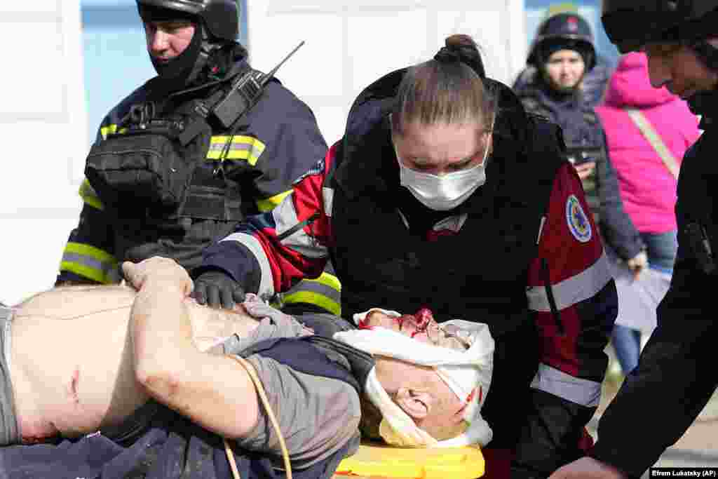 Medics evacuate a wounded man at the site. &nbsp;