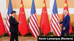 Chinese President Xi Jinping (left) and U.S. President Joe Biden in a file photo from a G20 leaders' summit in Bali, Indonesia, in November 2022.