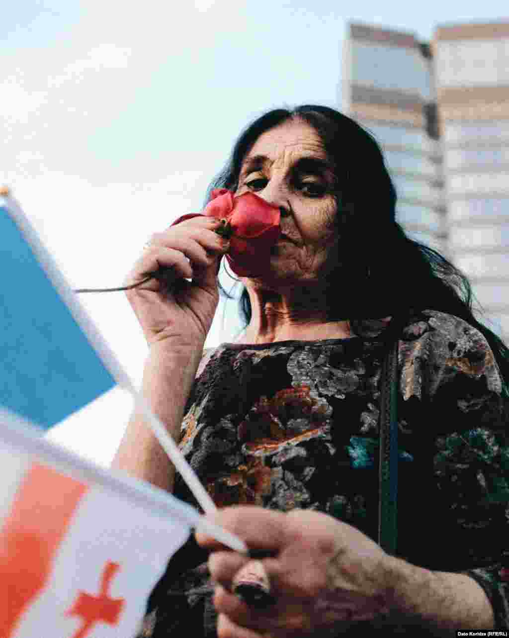 Another protester smells a rose as she attends the rally. Zurabishvili said her major concern is the fact that the bill is &quot;exactly a copy of [Russian President Vladimir] Putin&#39;s law.&quot;