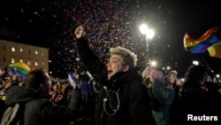 Хора празнуват пред гръцкия парламент след приемането на закона, позволяващ брака на еднополовите двойки