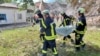 Rescuers remove a body at the site of a Russian missile strike in Romny on August 23.