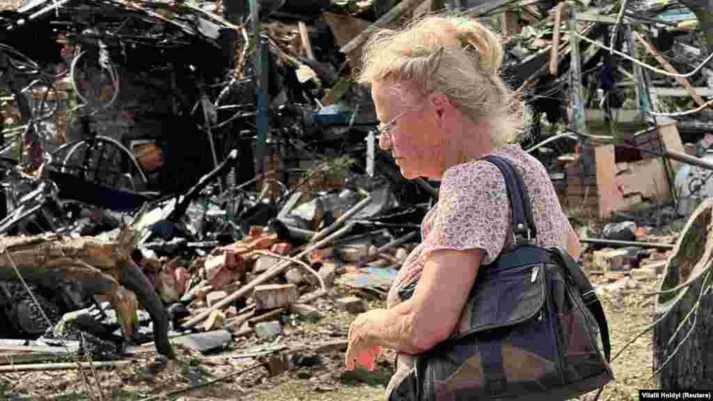 A woman views a damaged residential building in Kharkiv where Russian strikes killed a 73-year-old man and injured 11 others on June 23,&nbsp;regional Governor Oleh Synyehubov said on Telegram. Located just 35 kilometers from the border with Russia, Ukraine&#39;s second-largest city has undergone several days of repeated aerial guided bomb attacks that continue to maim and kill its civilians. &nbsp;