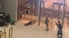 In this image grab taken from video footage, armed gunmen move past bodies of victims toward the doors of the Crocus City Hall in Krasnogorsk, outside Moscow, on March 22. At least 140 people were killed in the attack. 