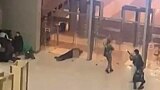 In this image grab taken from video footage, armed gunmen move past bodies of victims toward the doors of the Crocus City Hall in Krasnogorsk, outside Moscow, on March 22. At least 140 people were killed in the attack. 