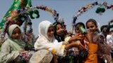 Girls reach out to collect snacks during celebrations to mark the birth anniversary of the Prophet Muhammad in Karachi, Pakistan, on September 29.