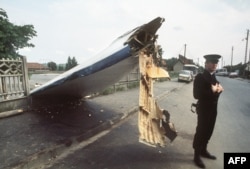 A policeman guards a chunk of the Tu-144 in Goussainville on June 4, 1973.